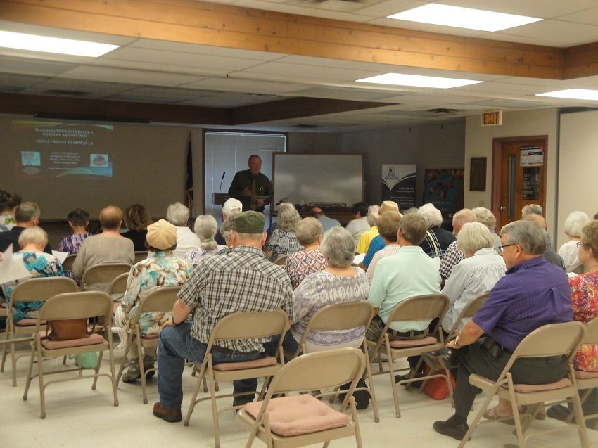 Man Conducting A Meeting In Front Of Elderly People
